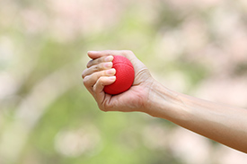 a woman's hand squeezing a stress ball